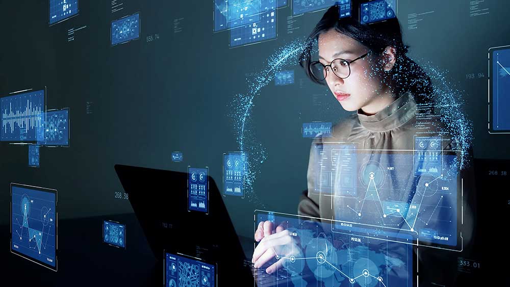 Young female student examining data on a laptop